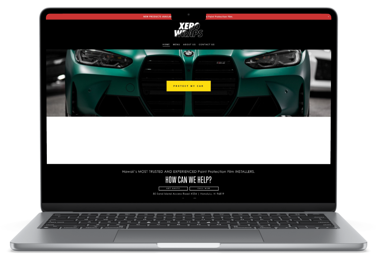 A laptop computer is open to a website for a window tinting company.