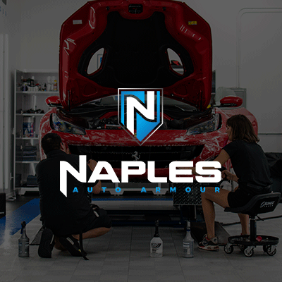 A naples auto armour logo with a red car in the background