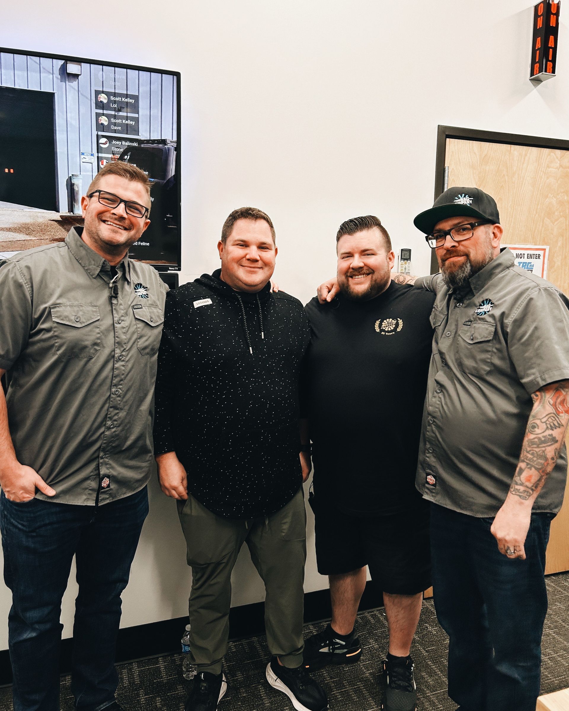 A group of men are posing for a picture together in a room.