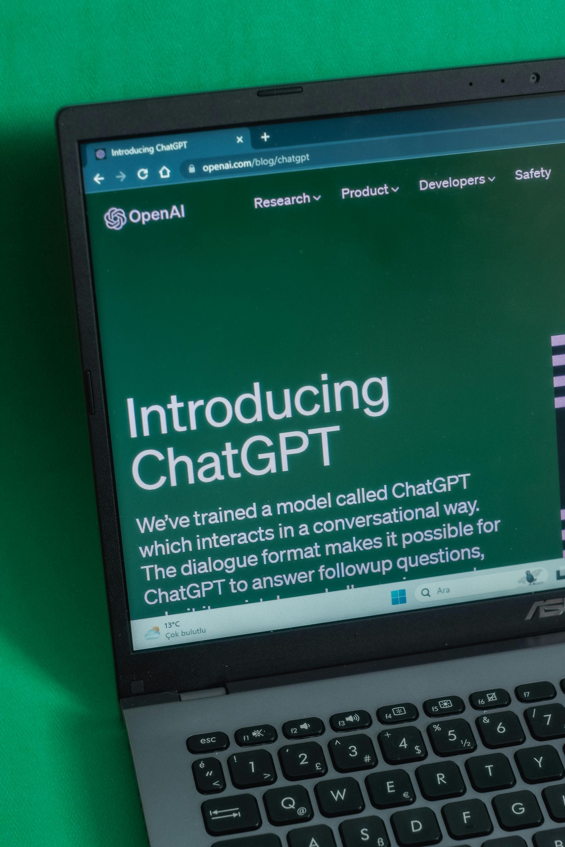 A laptop computer is open to a page that says introducing chatgpt.