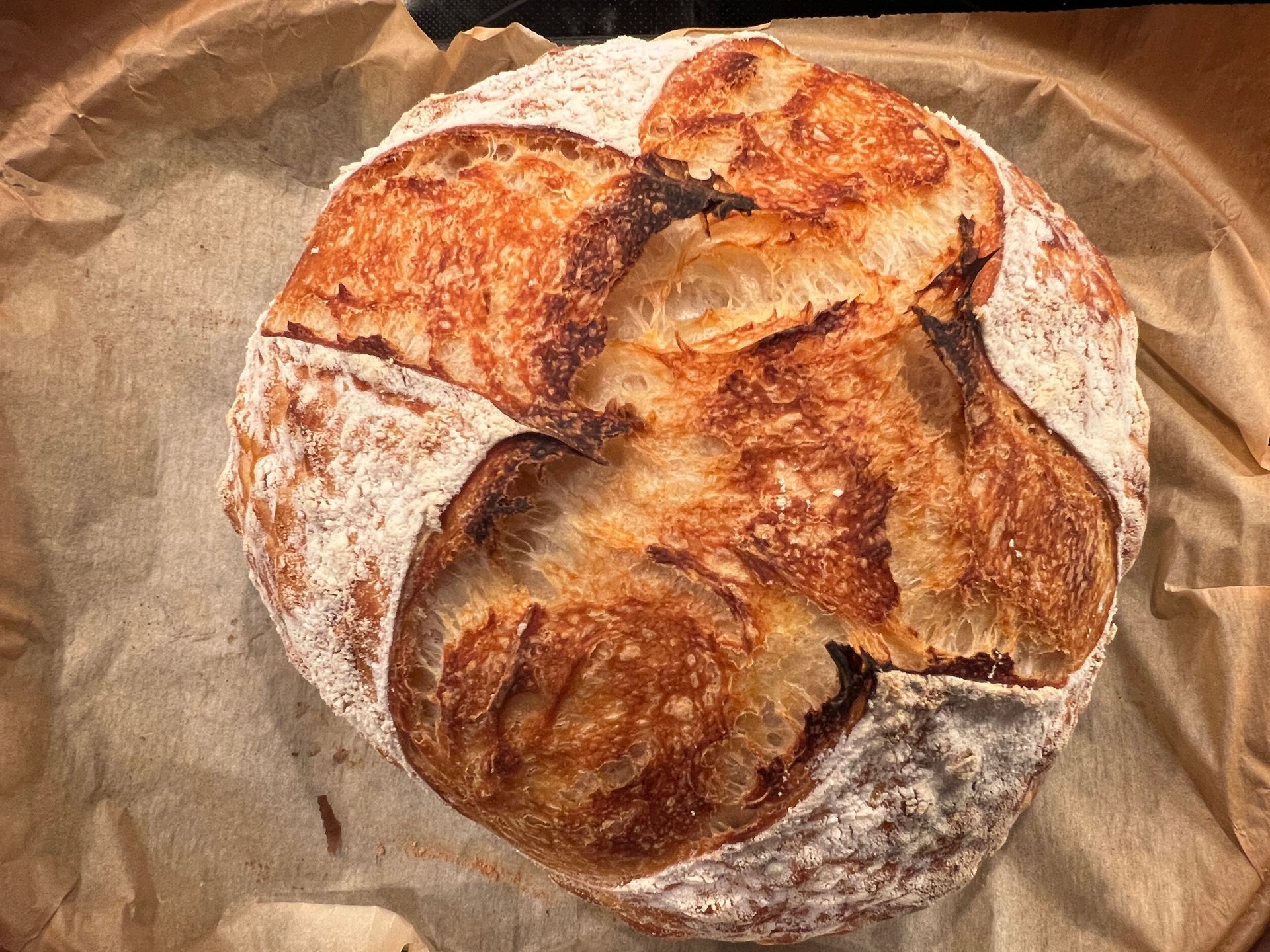 A loaf of bread is sitting on a piece of brown paper.