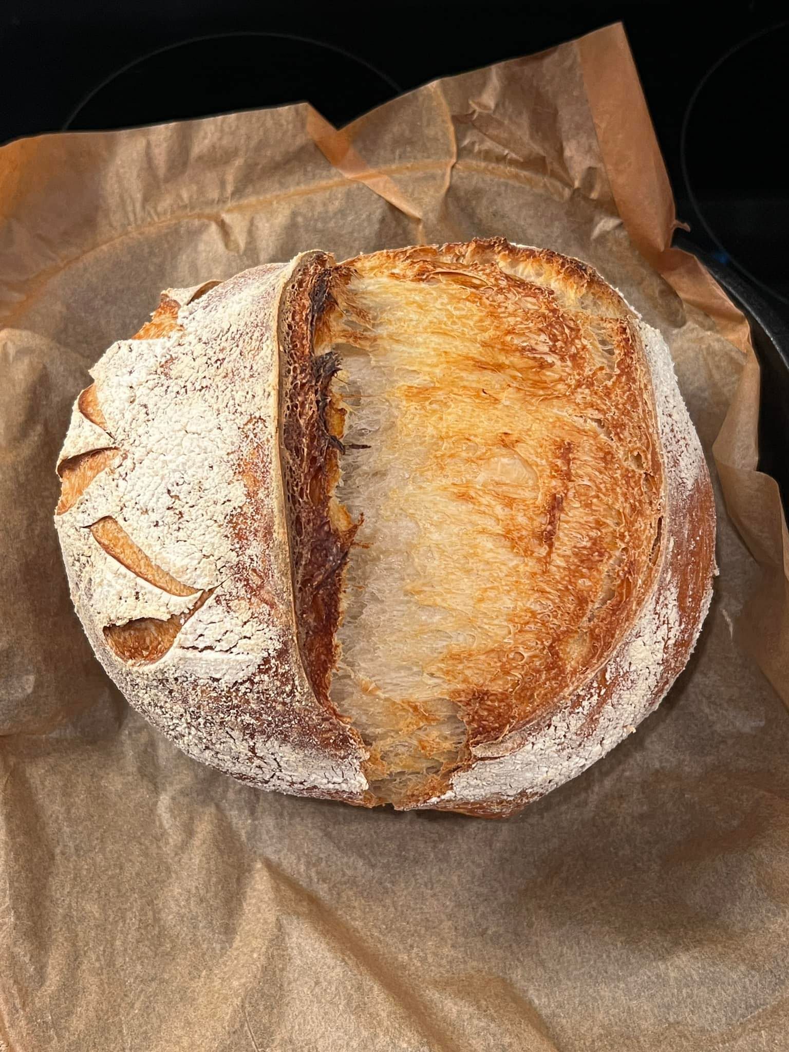 A loaf of bread is sitting on top of a piece of brown paper.
