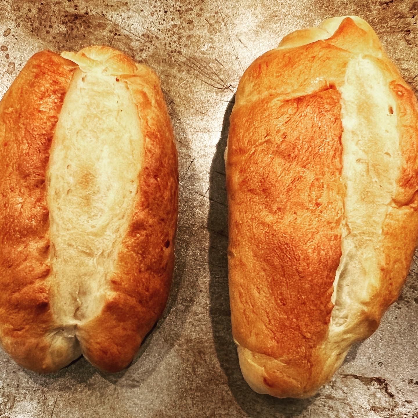 Two loaves of bread are sitting on a table