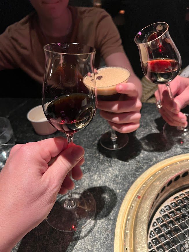 A group of people are toasting with wine glasses in a restaurant.