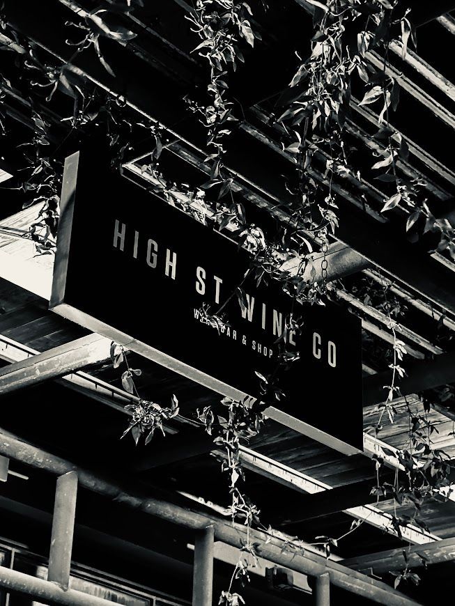 A black and white photo of a sign for high st wine co.