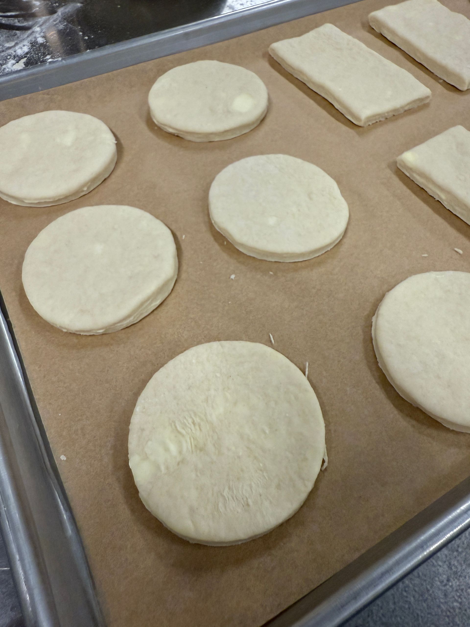 A bunch of cookies are sitting on a baking sheet