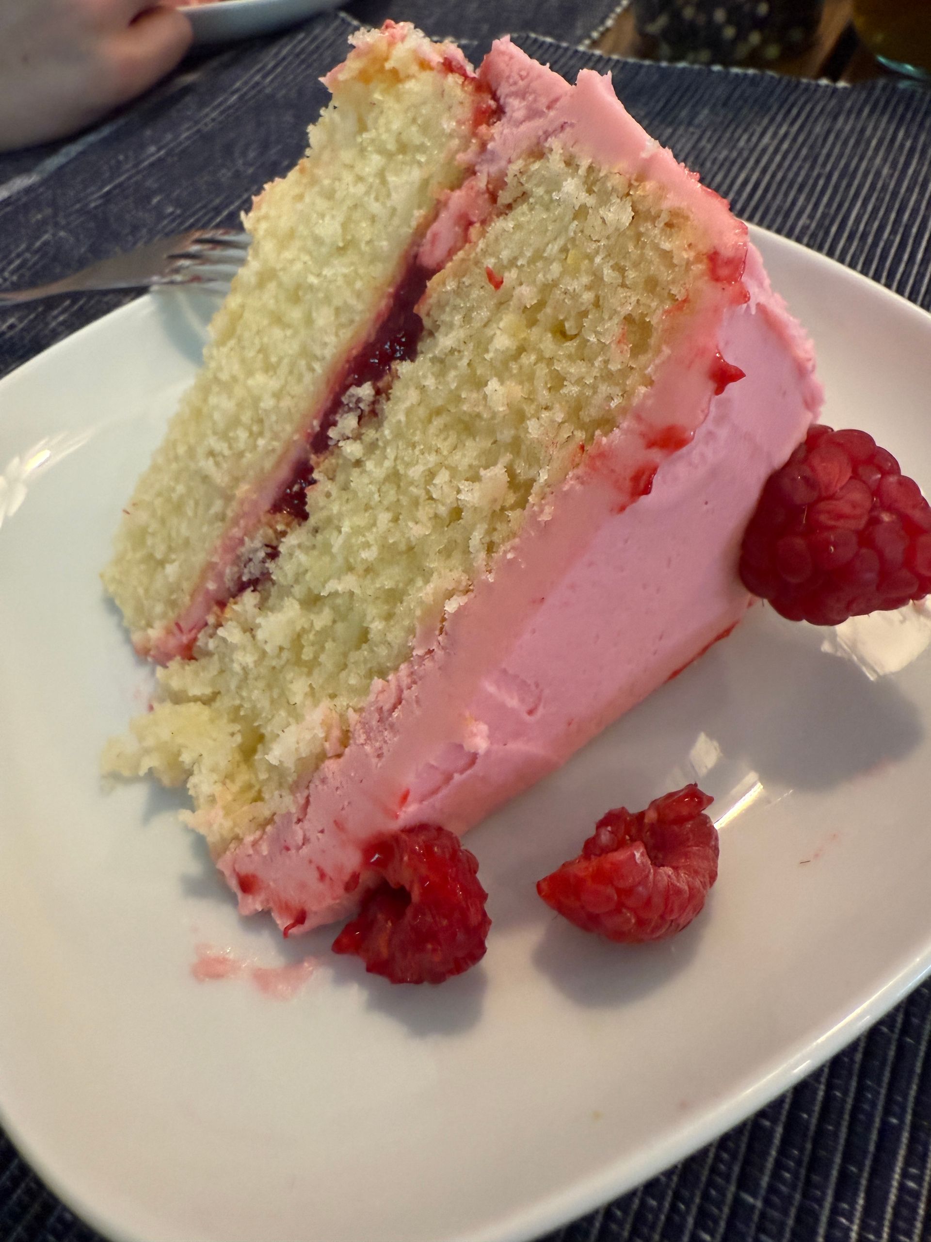 a piece of cake with pink frosting