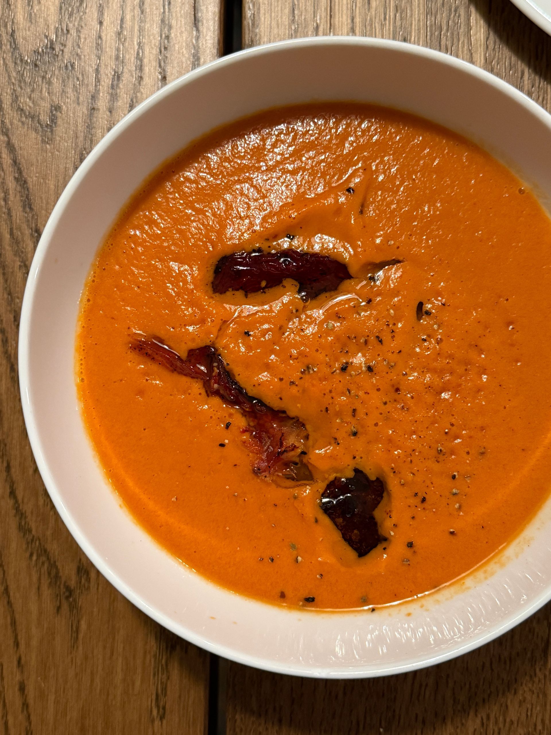 Bowl of tomato soup mixed in a Vitamix blender.