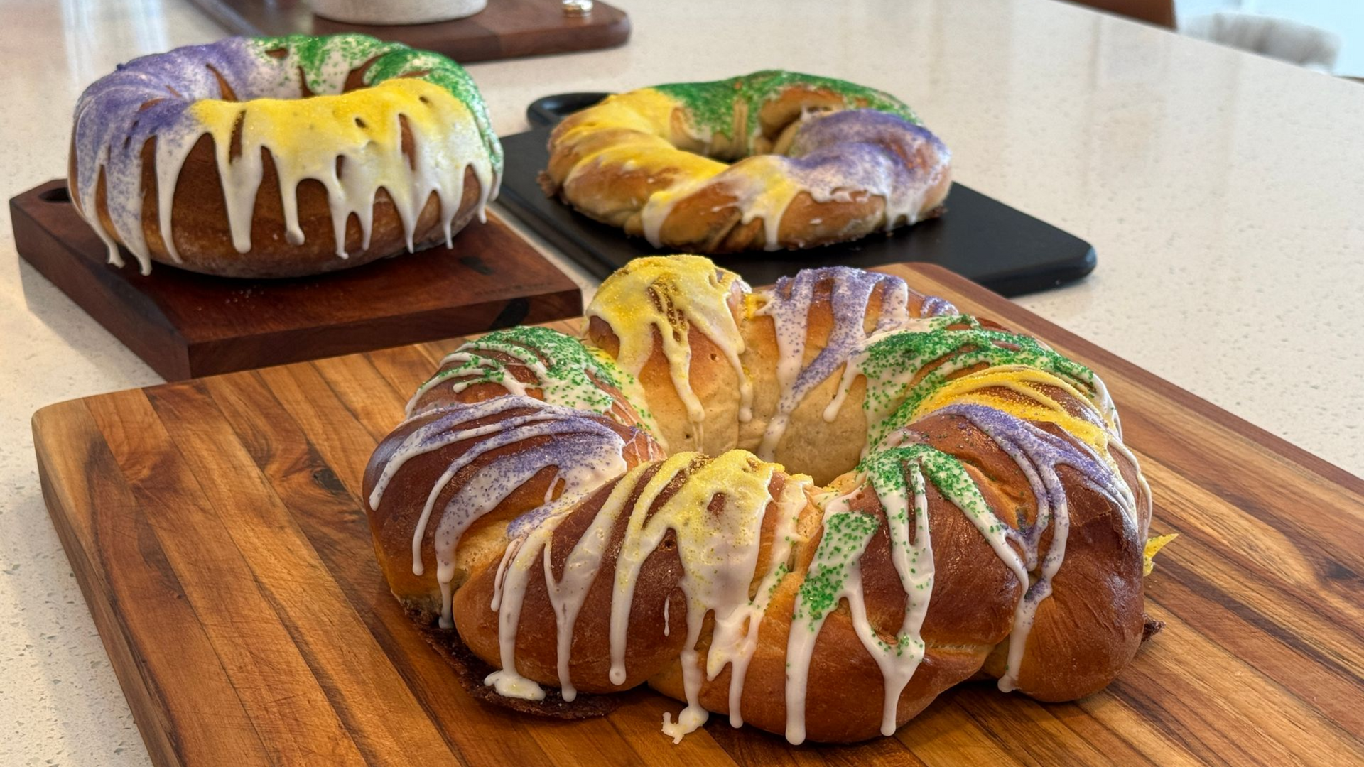 three king cakes on cutting boards