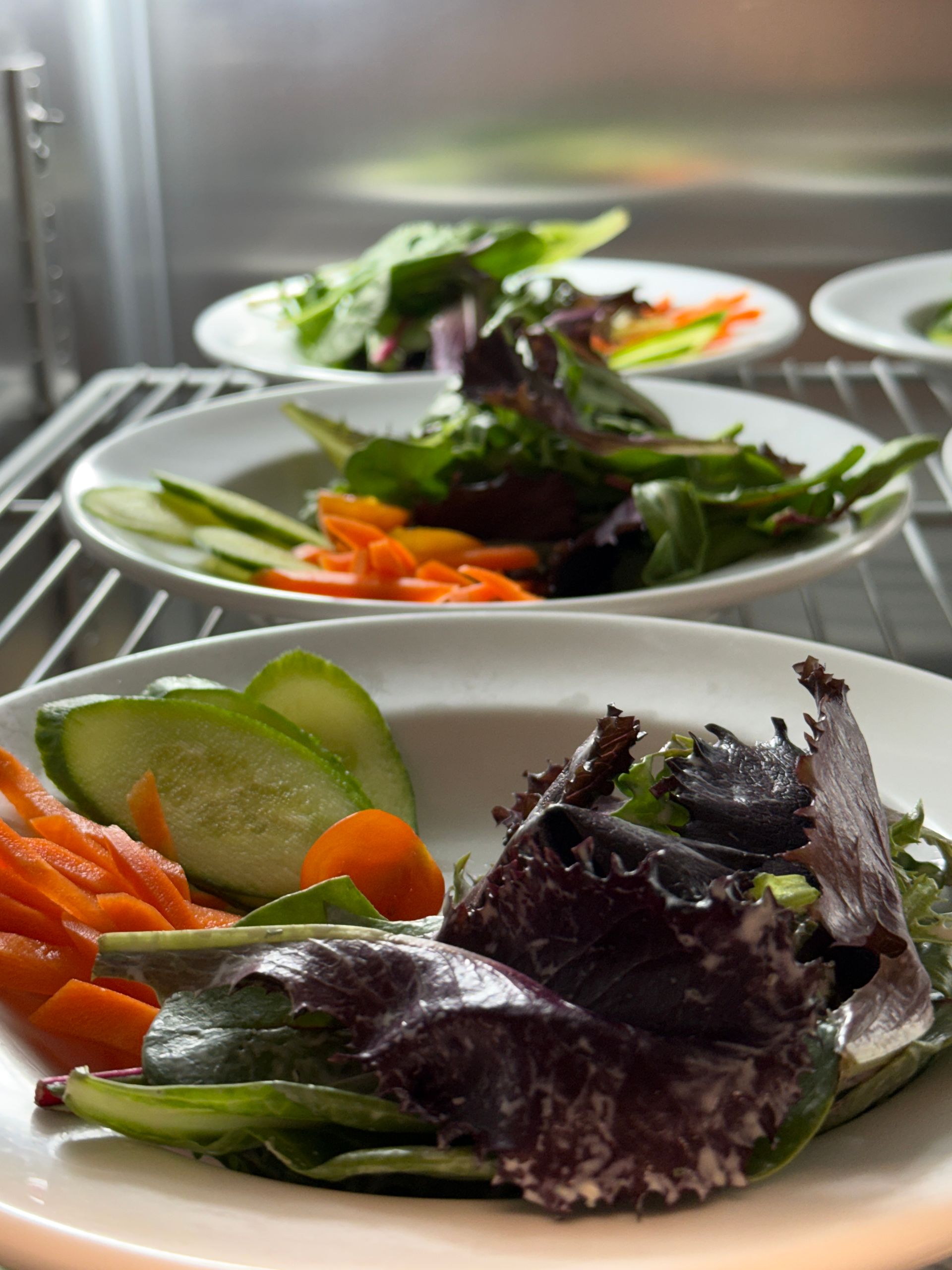 A close up of bacon wrapped olives on a piece of bread on a table.