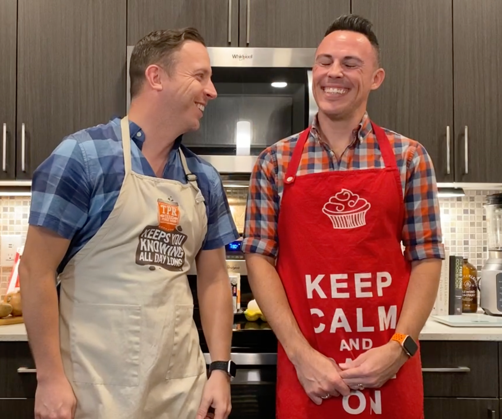 Two men wearing aprons that say keep calm and on