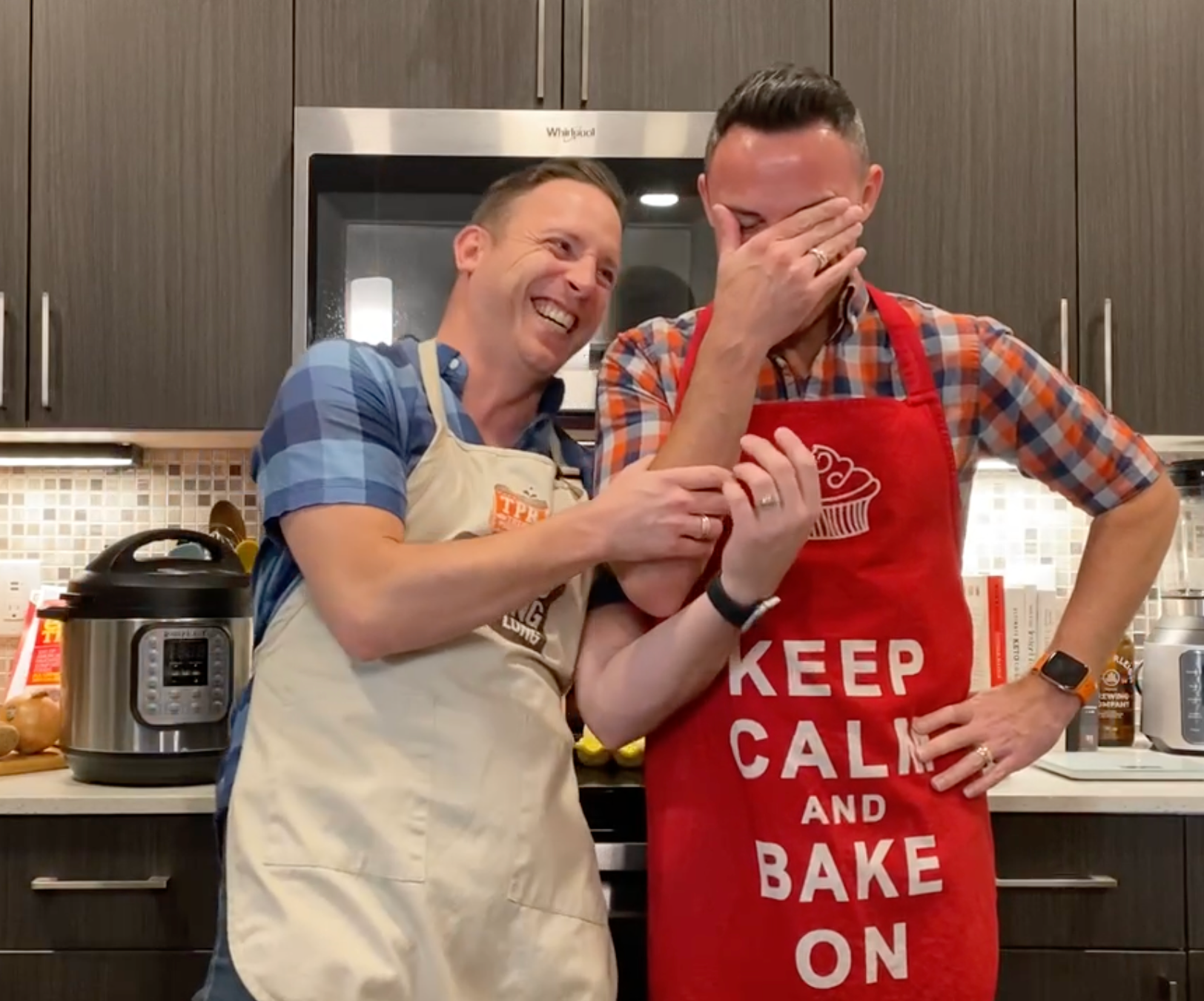 Two men wearing aprons that say keep calm and bake on