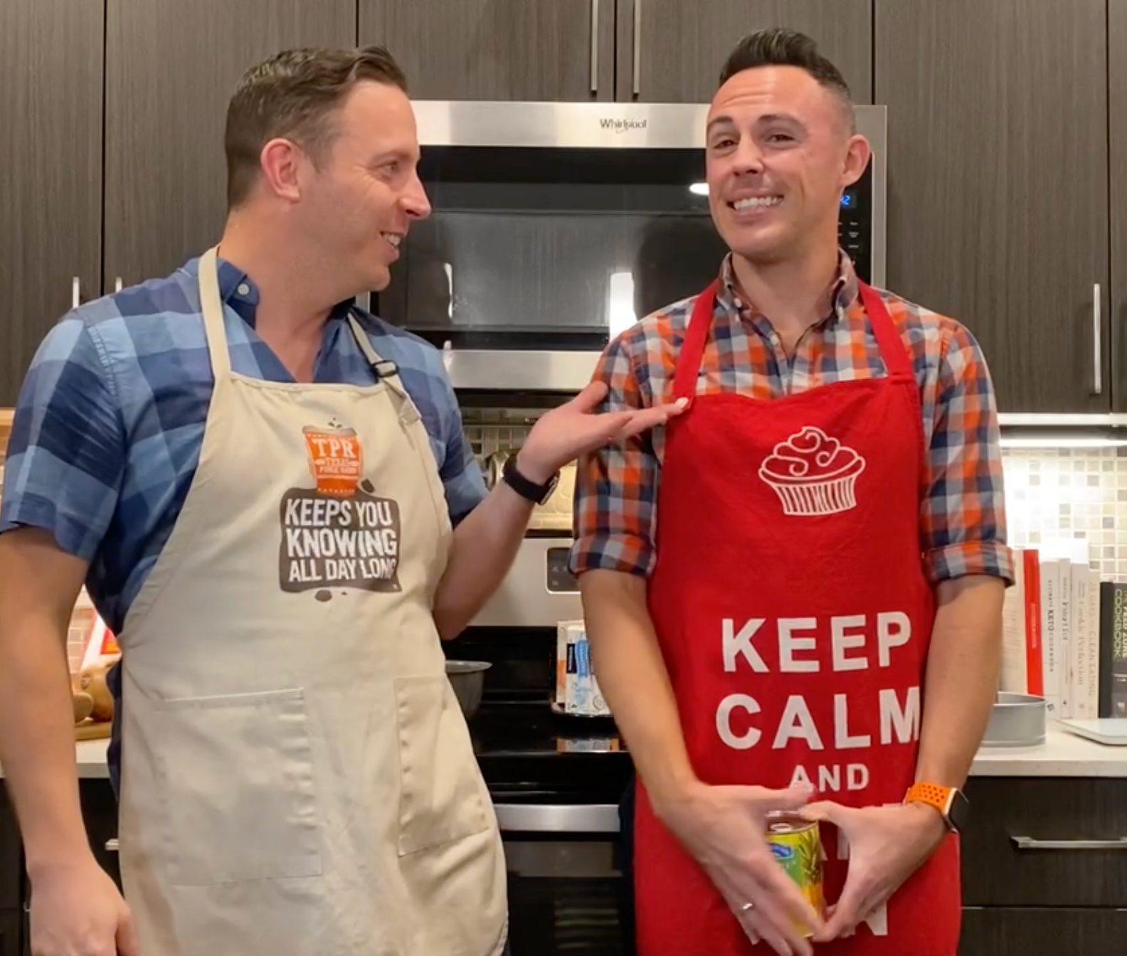 Two men wearing aprons that say