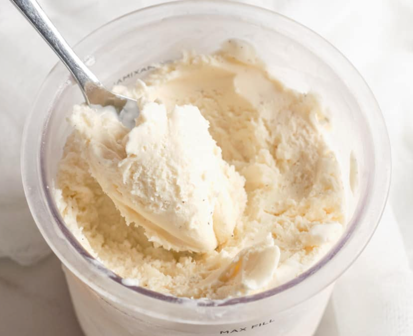 A bowl of ice cream with a spoon in it.