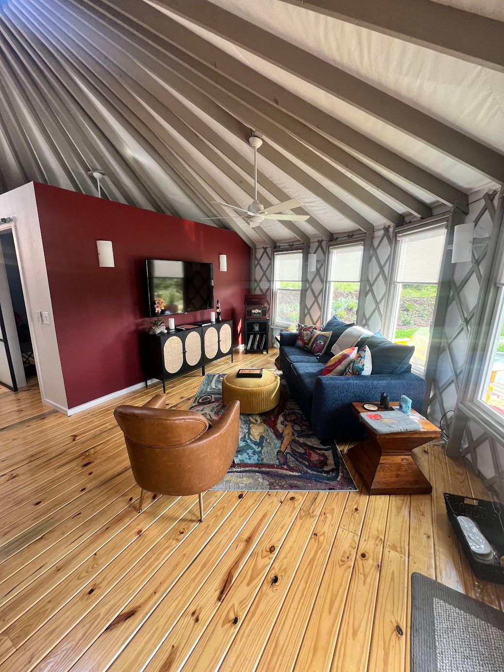 A living room with a couch , chairs , and a television.