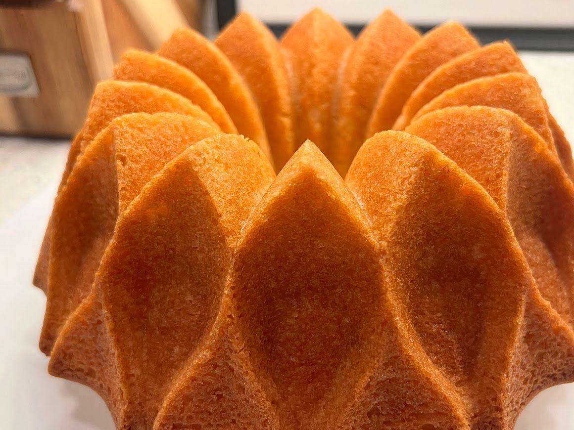 A bundt cake is sitting on a white table.