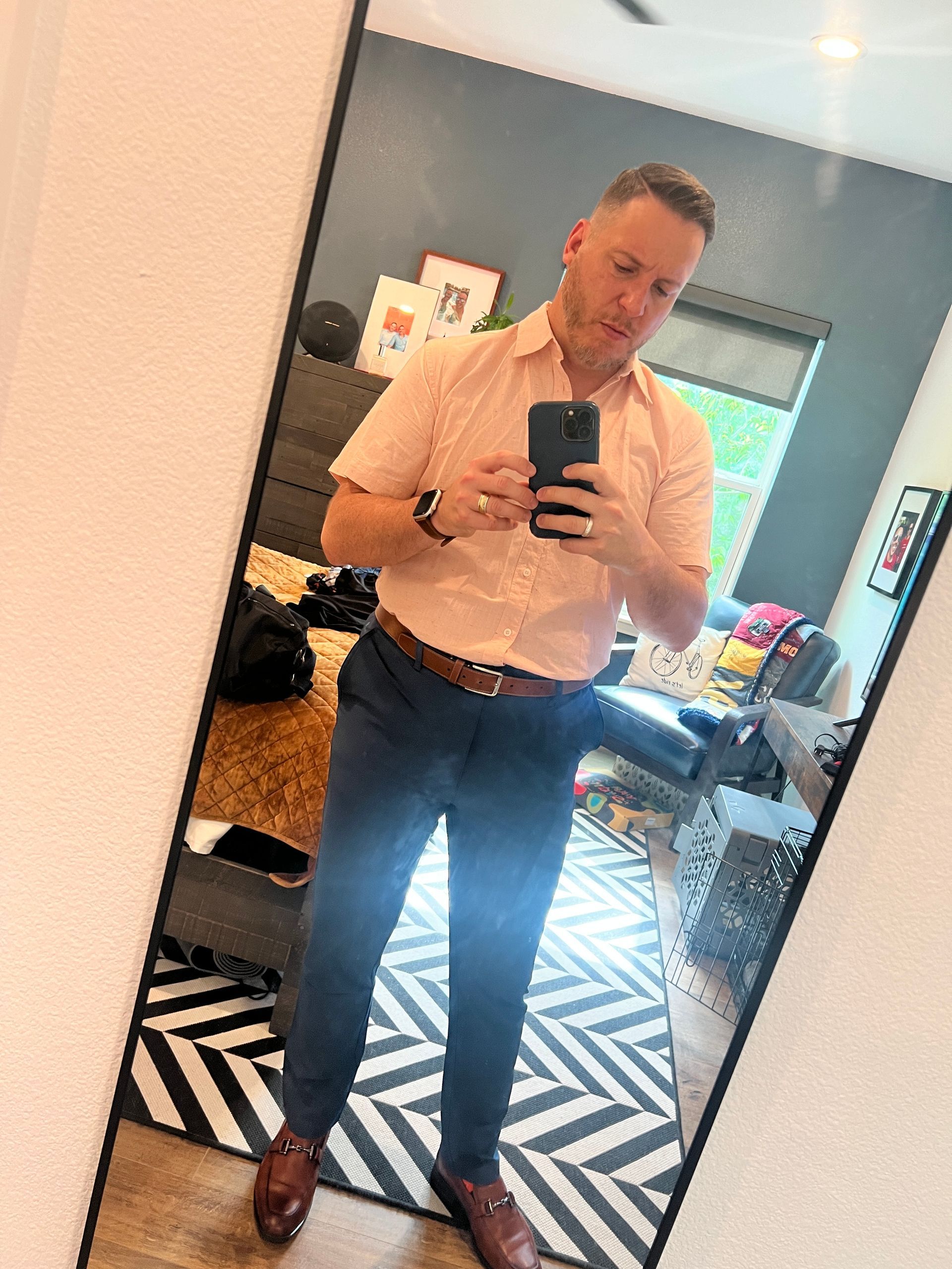 A man is taking a selfie in front of a mirror.