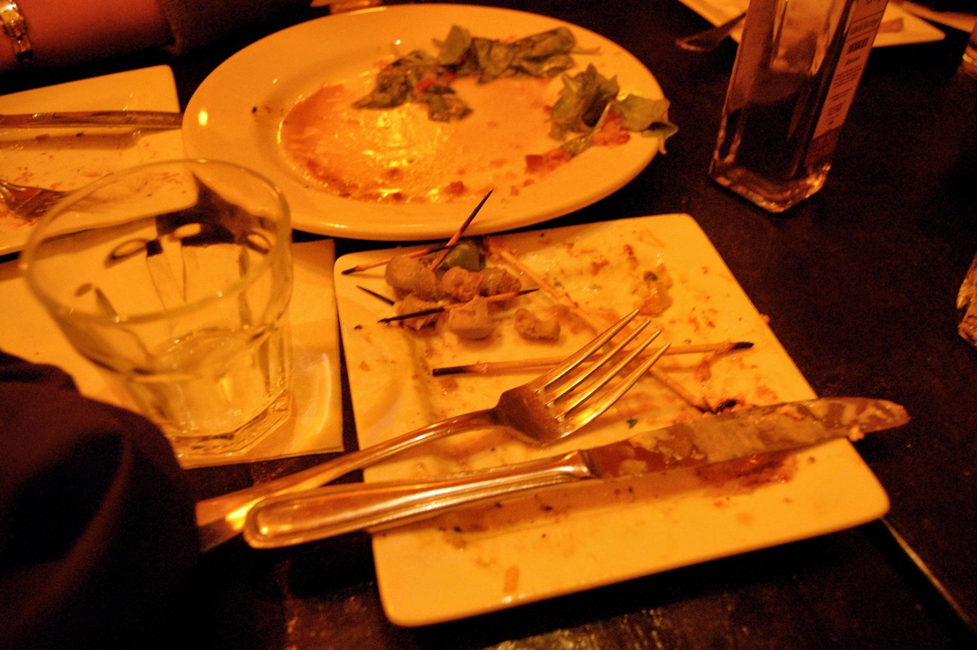 Dirty plates with dirty silverware sitting atop.