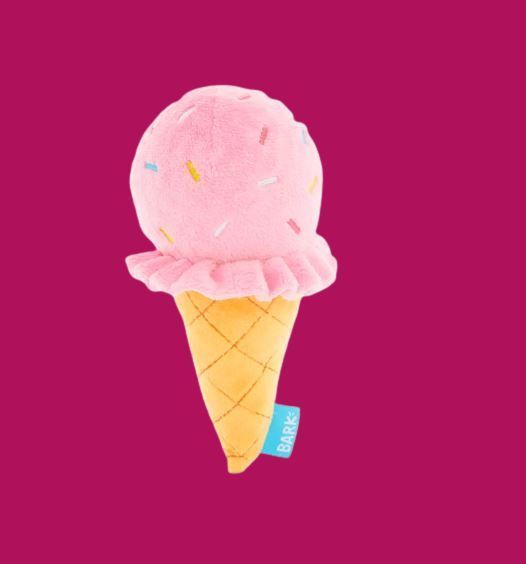 A stuffed ice cream cone with pink ice cream and sprinkles