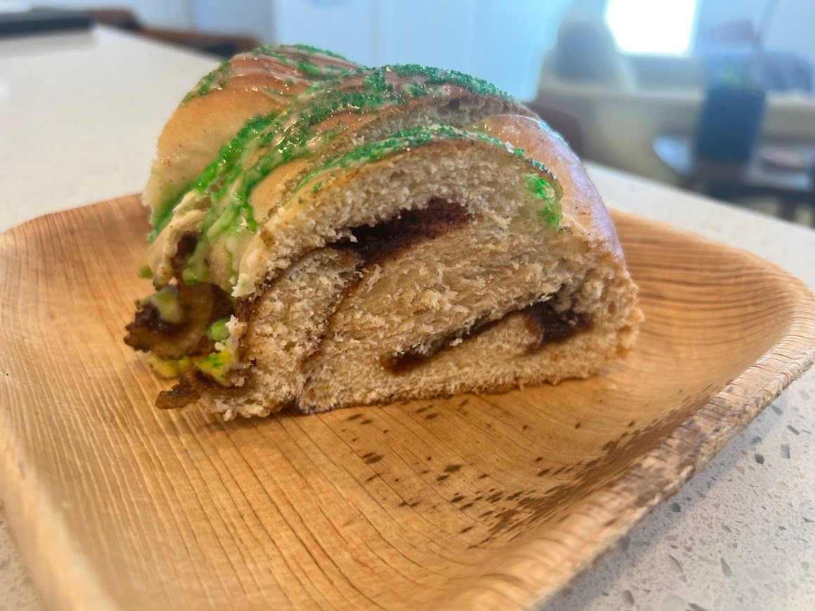 A close up of a piece of bread on a wooden plate.