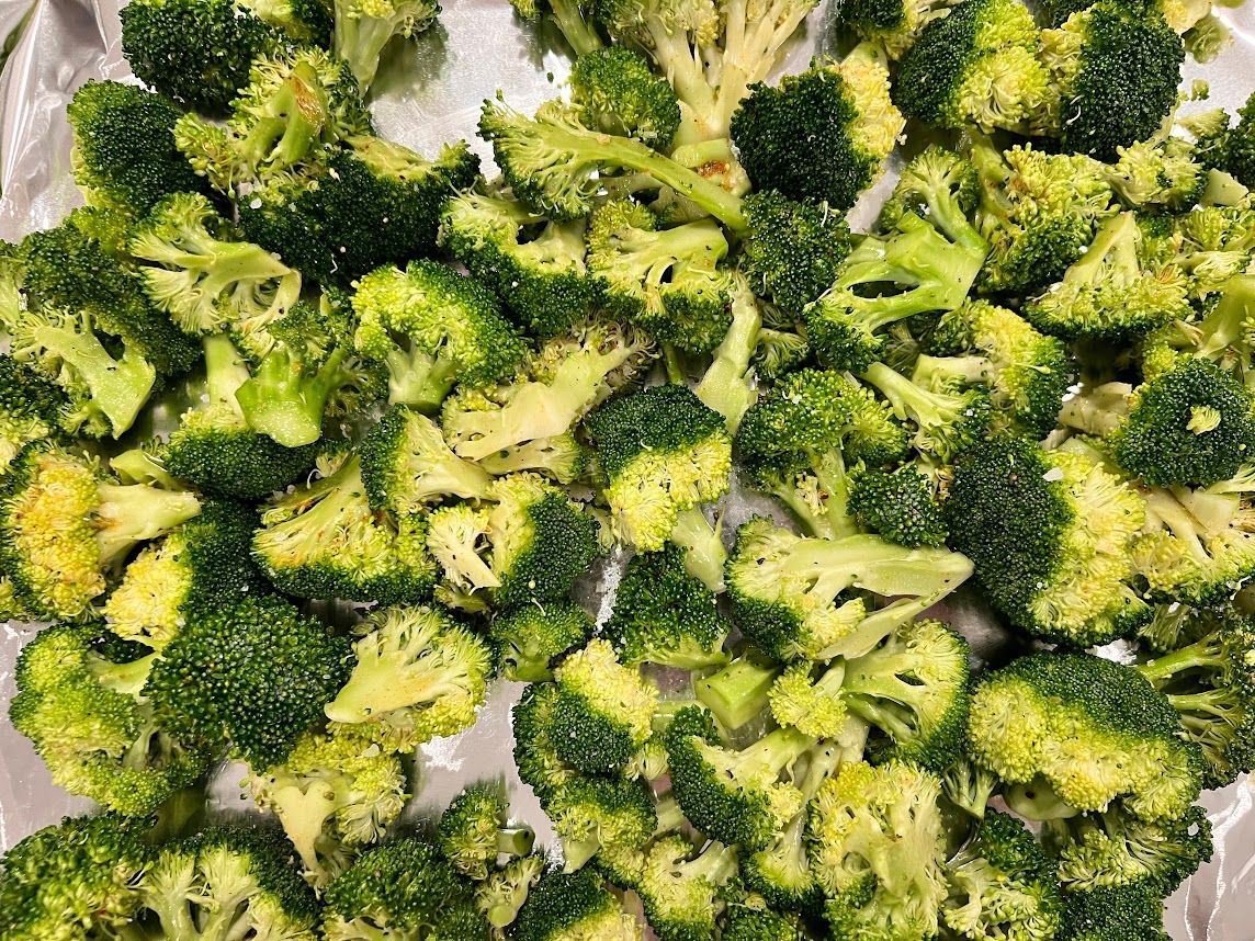 A pile of broccoli is sitting on a table.