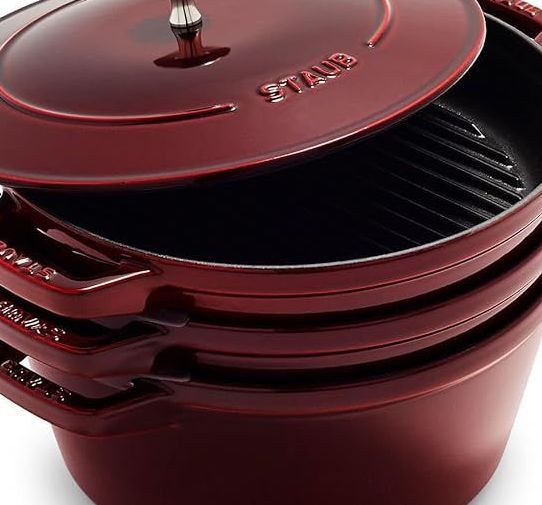 A stack of red staub pots and pans
