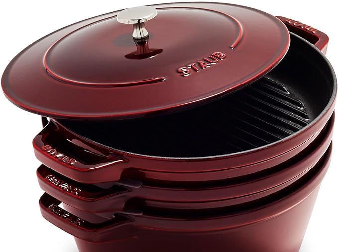 A stack of red pots with a lid on top of each other.