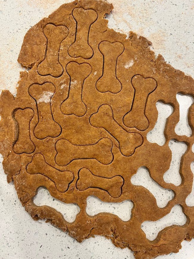 A piece of dough with bones cut out of it