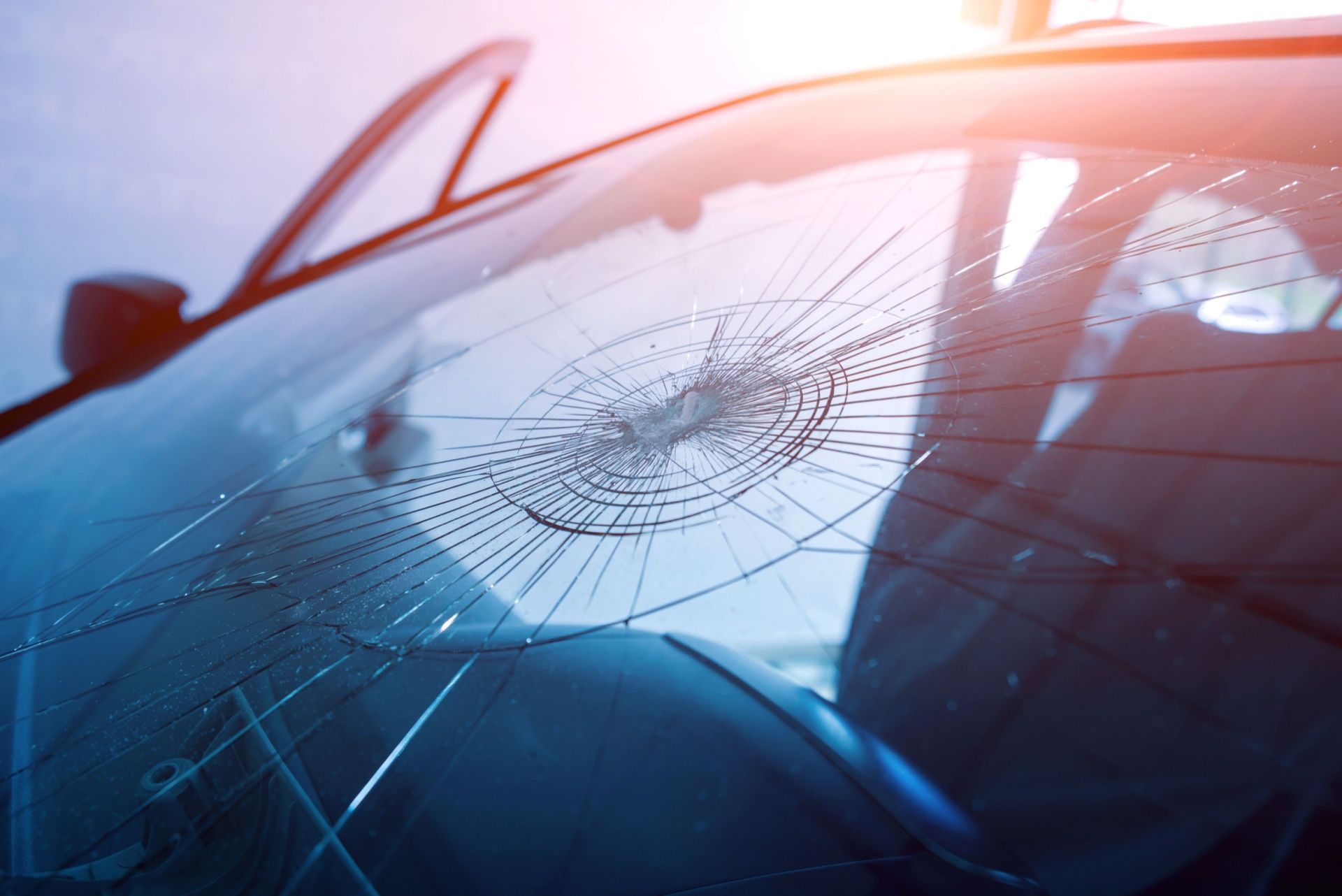 A close up of a broken windshield on a car.