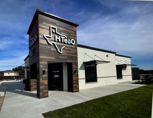 A building with a lot of windows and a tree in front of it