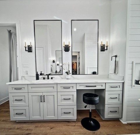 A bathroom with two sinks , a toilet , and a large mirror.