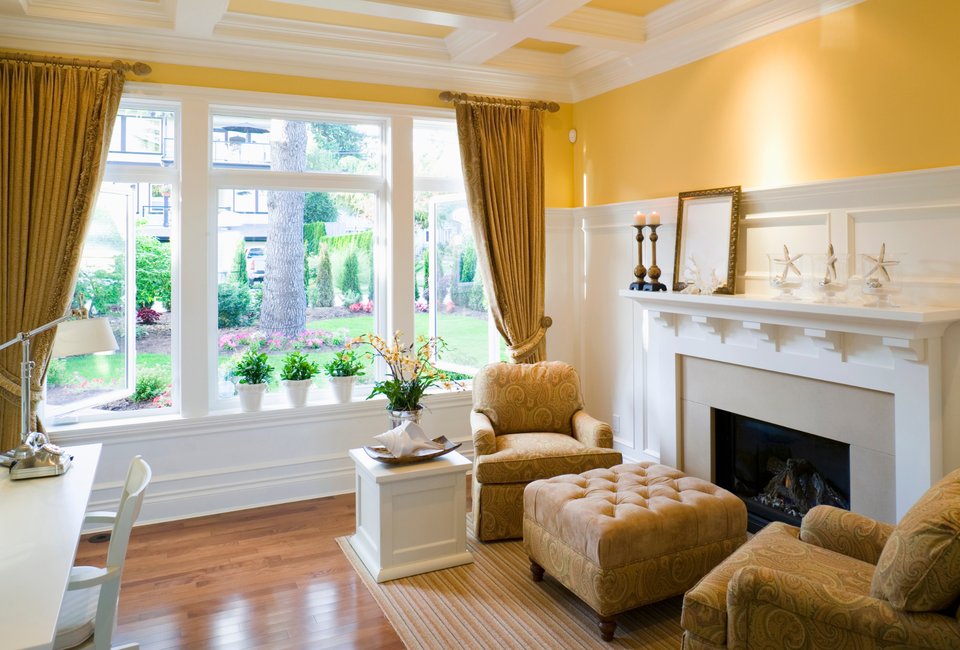 A living room with yellow walls and a fireplace