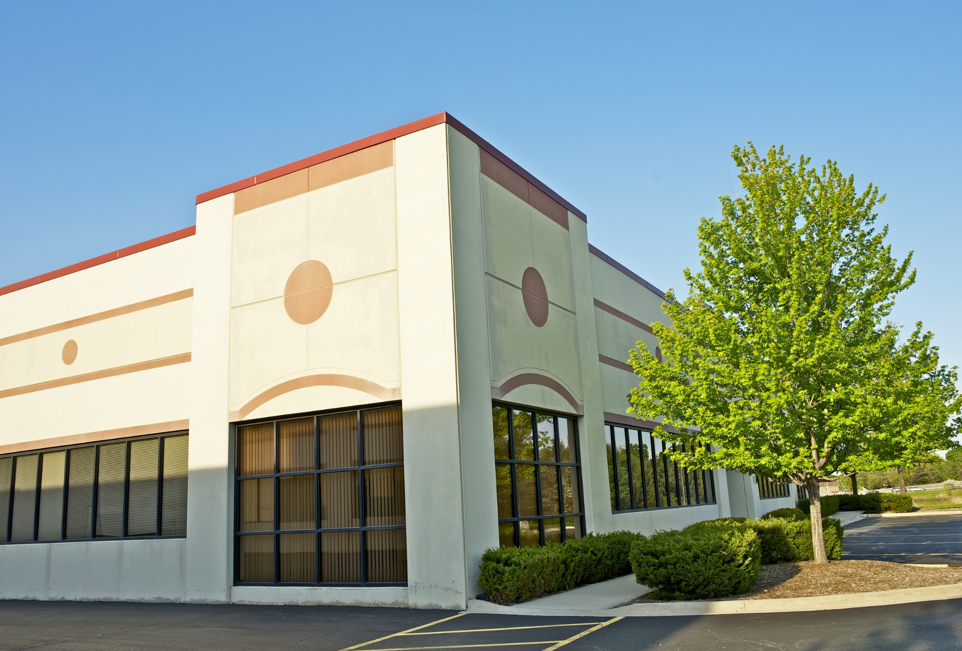 A building with a lot of windows and a tree in front of it