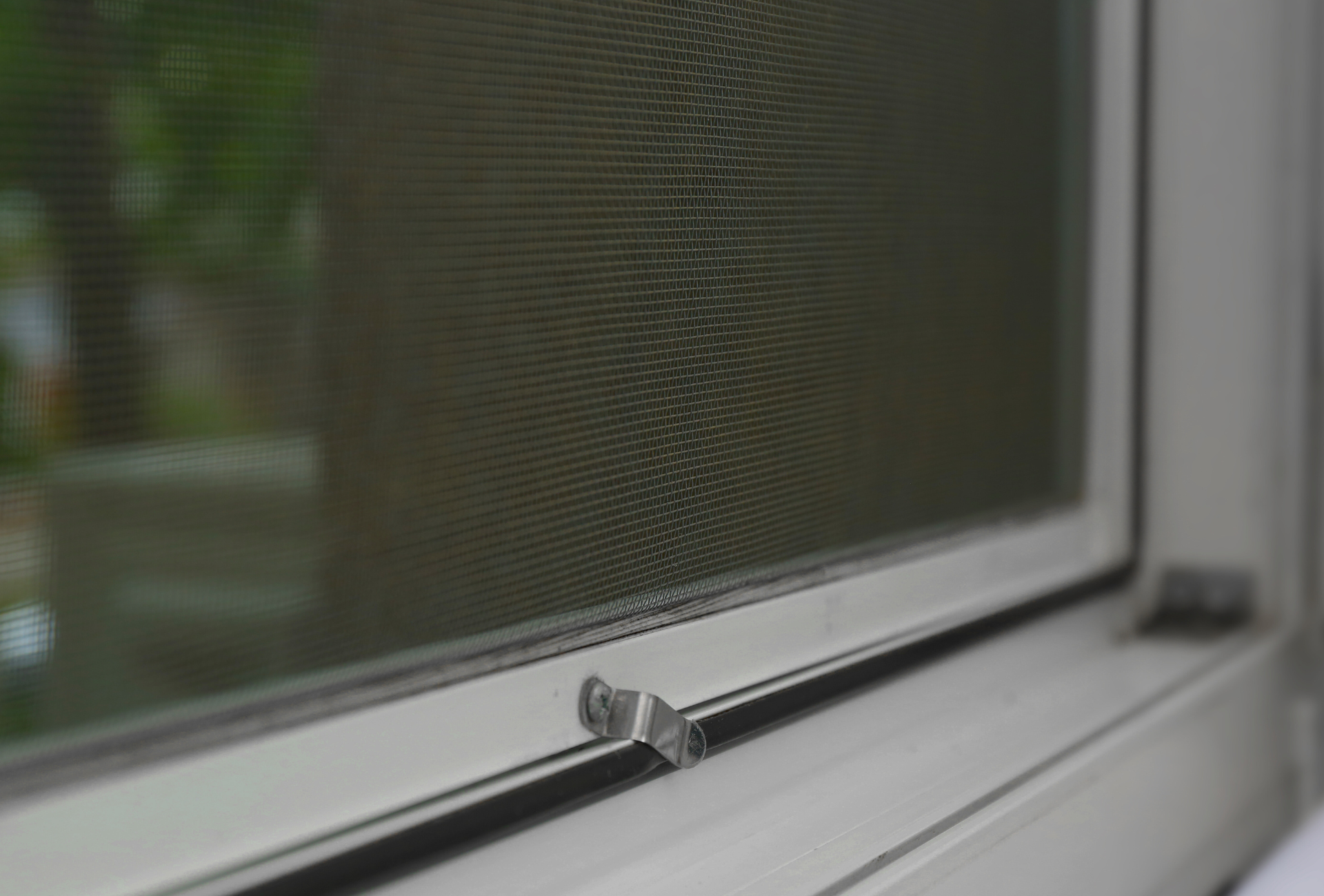 A close up of a window with a screen on it.