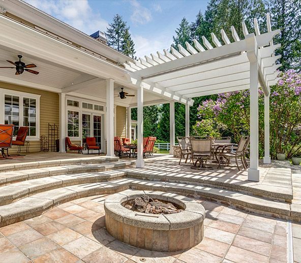 A man is hammering a nail into a wooden fence.