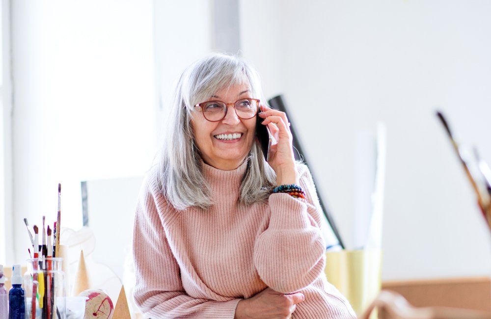 Old Woman Using Her Phone — Forsyth, NC — Safe Ride Transportation