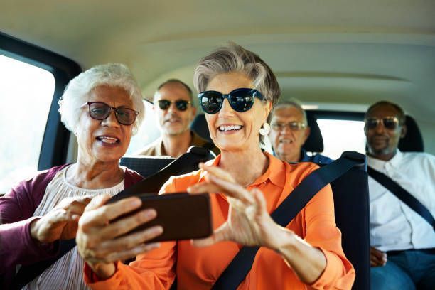 A group of passengers taking a selfie inside an elderly transportation van.
