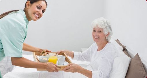 In-home Care — Staff Giving Food To Old Woman in Oklahoma City, OK