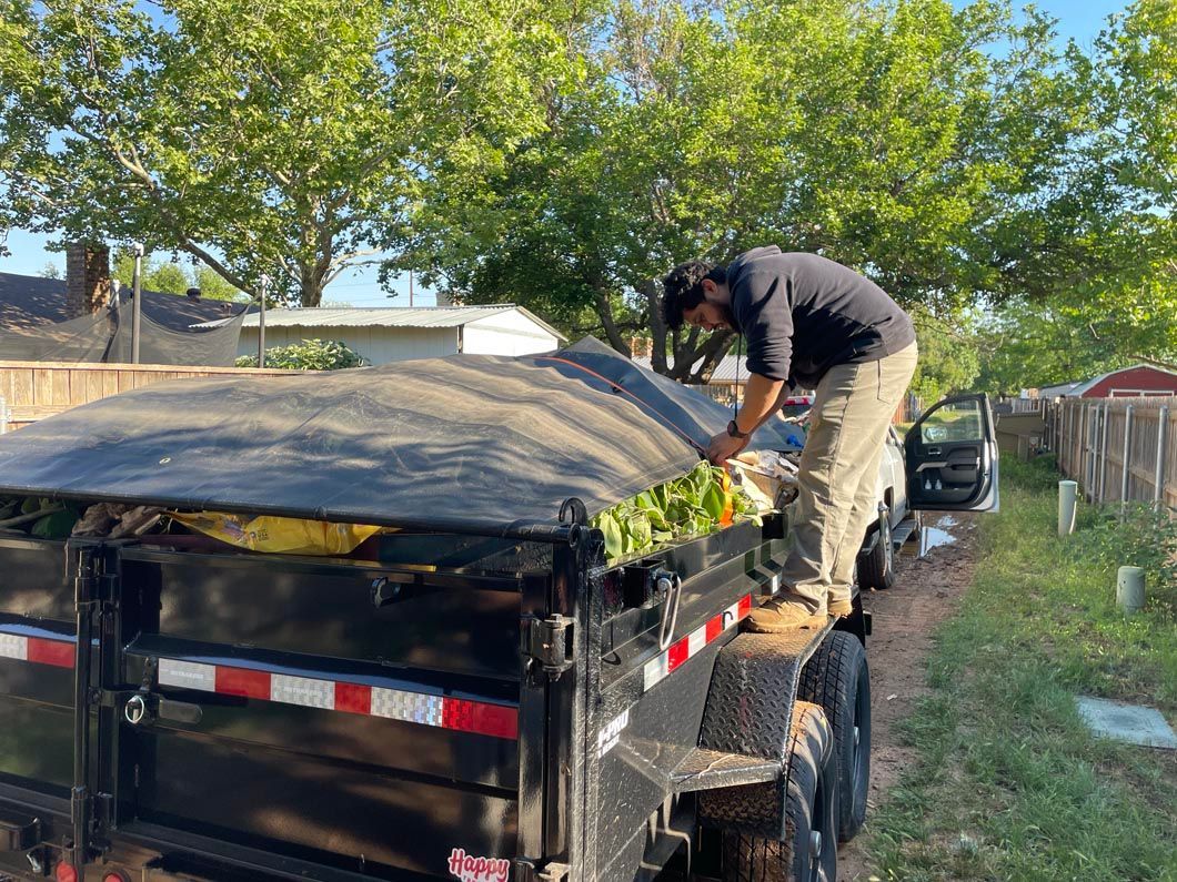 A man is standing on top of a trailer.