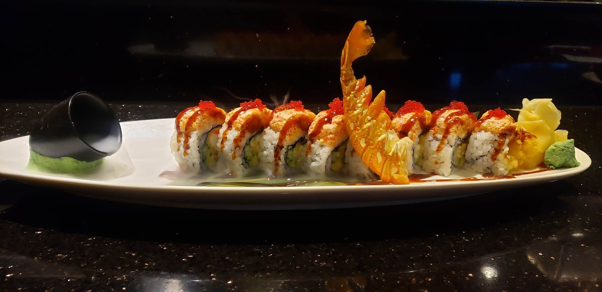 A close up of a plate of sushi on a table.