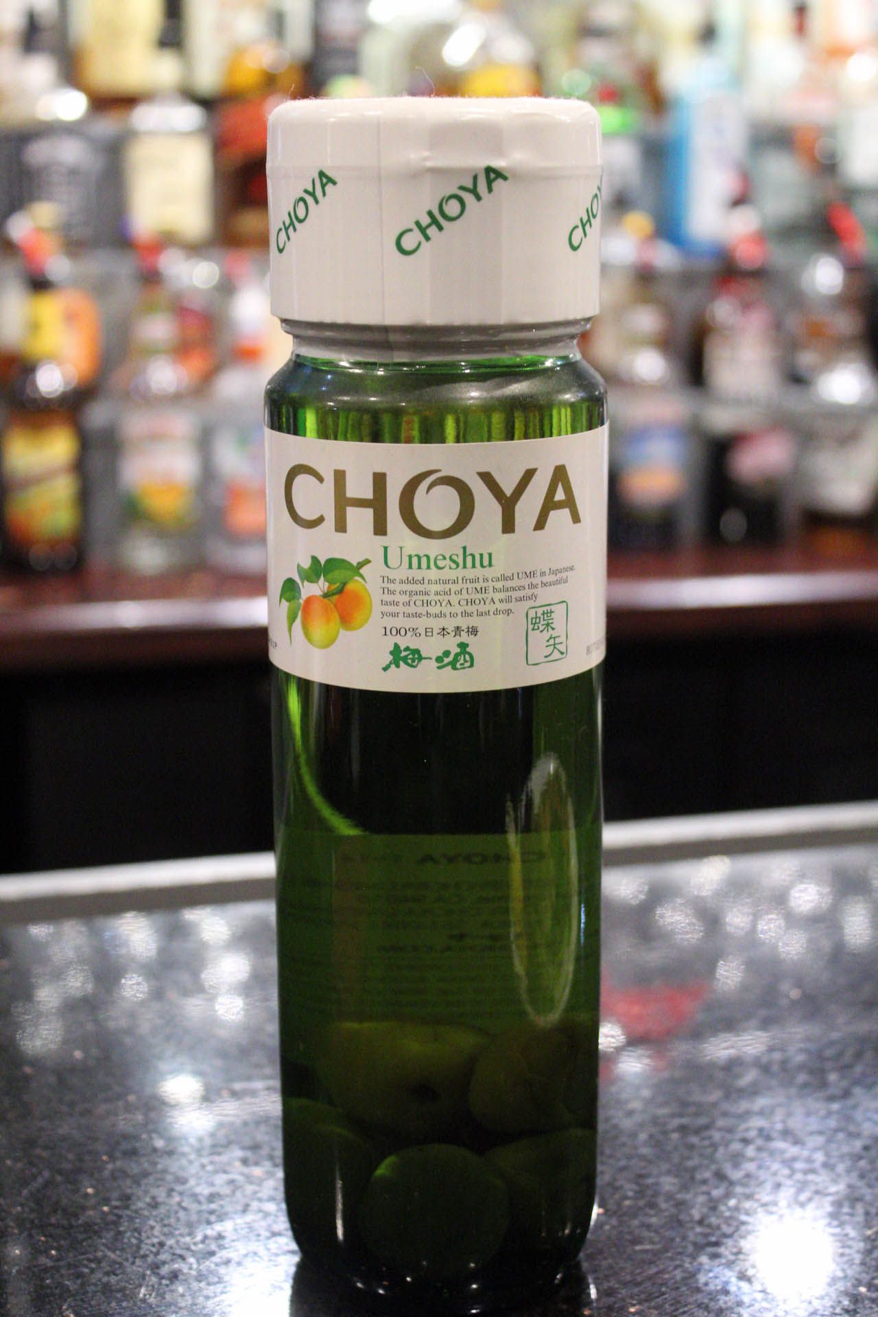 A bottle of choya sits on a bar counter