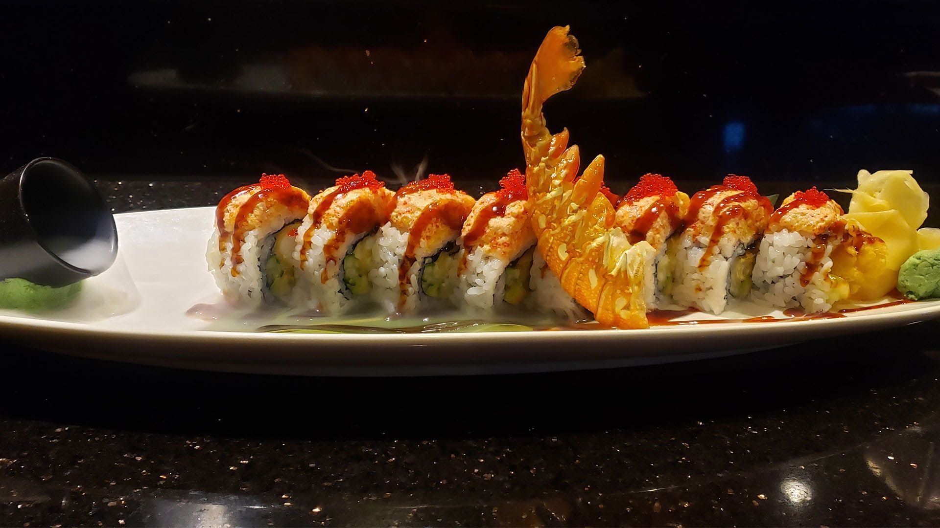 A close up of a plate of sushi on a table.