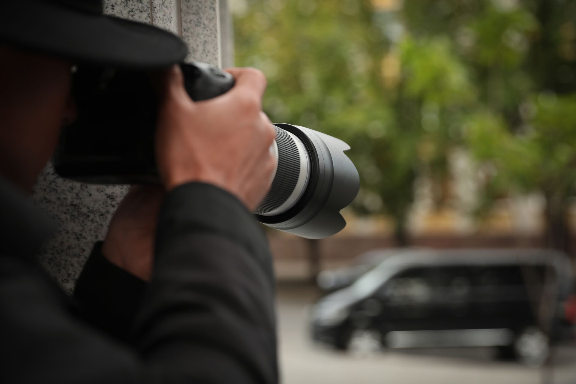 A private detective is using a camera