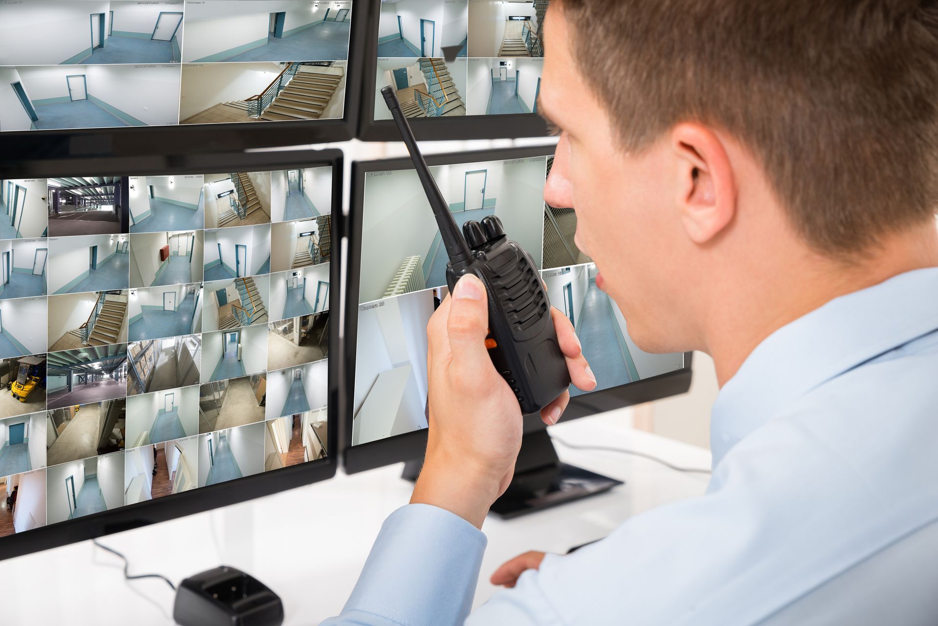 Man watching the video cam and talking in a walky-talky