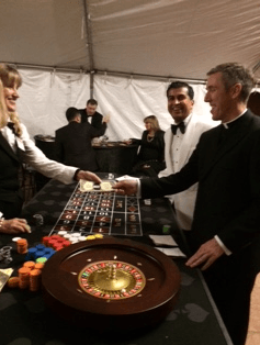 A man in a tuxedo is playing a game of roulette