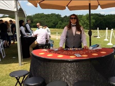 A woman is standing in front of a poker table.