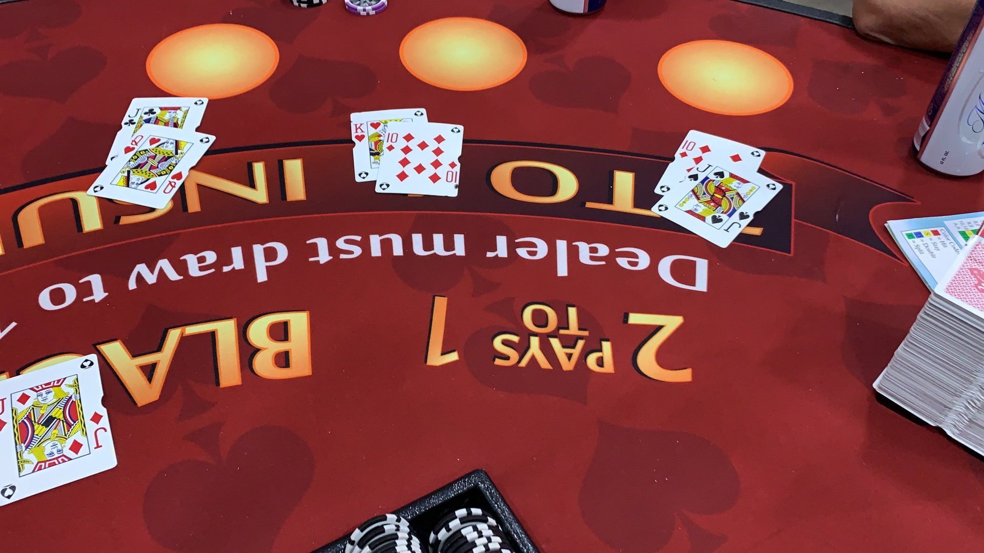 Overhead view of a blackjack table with face cards showing