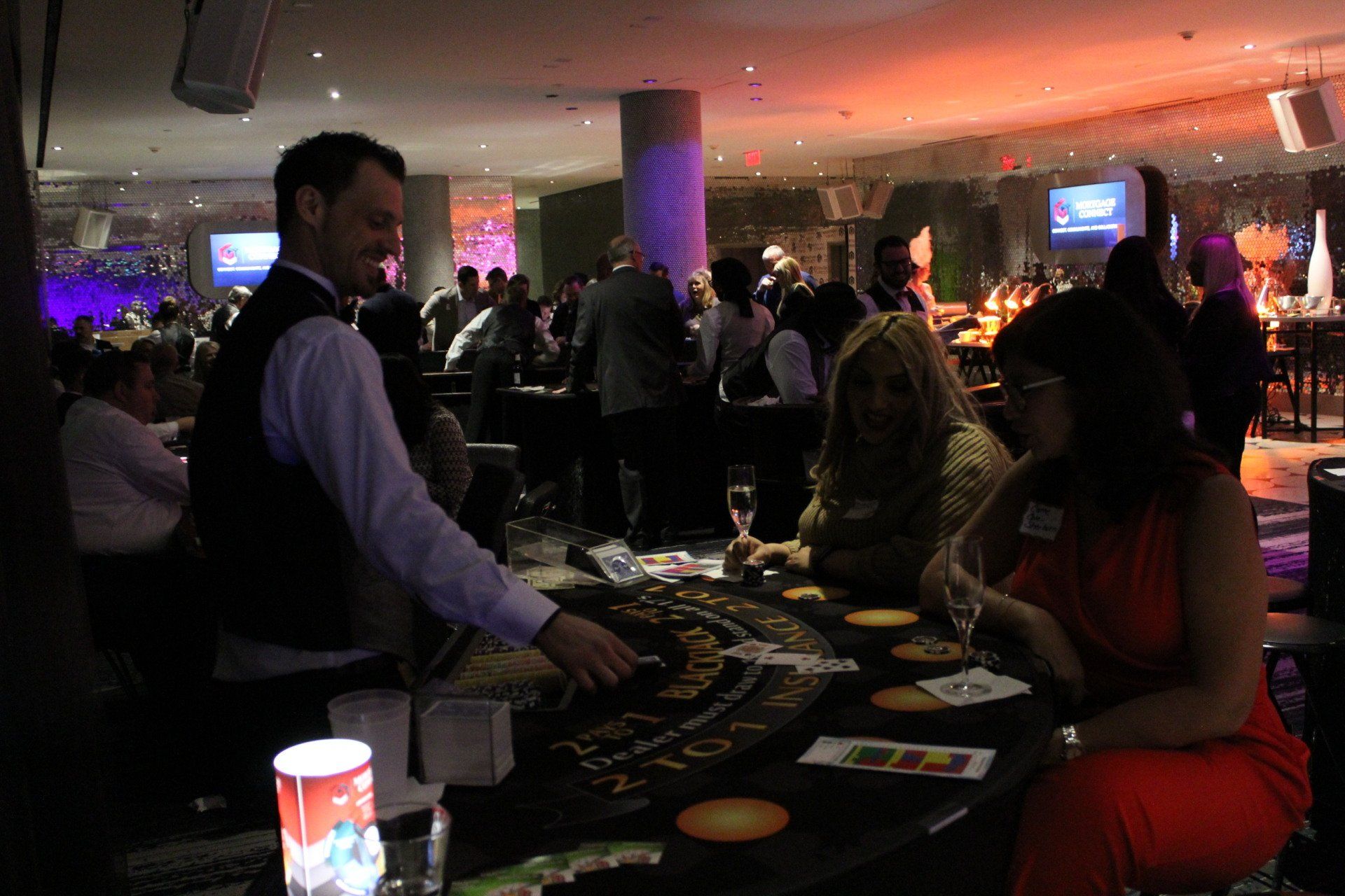 A group of people are playing a game of blackjack in a casino.