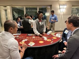 A group of people are playing a game of blackjack at a table.