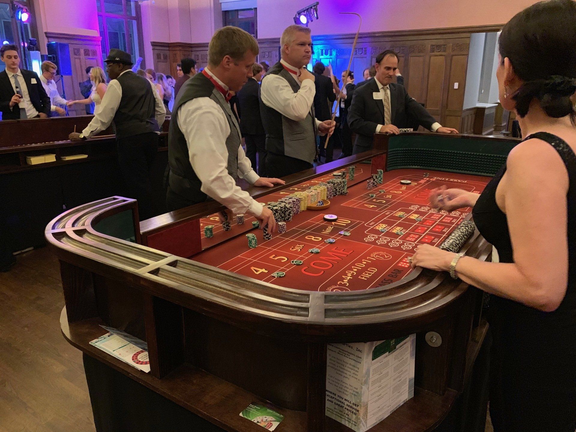 A group of people are playing roulette at a casino table.